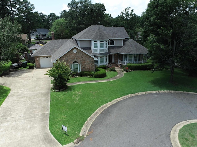 view of front of home featuring a front lawn and a garage