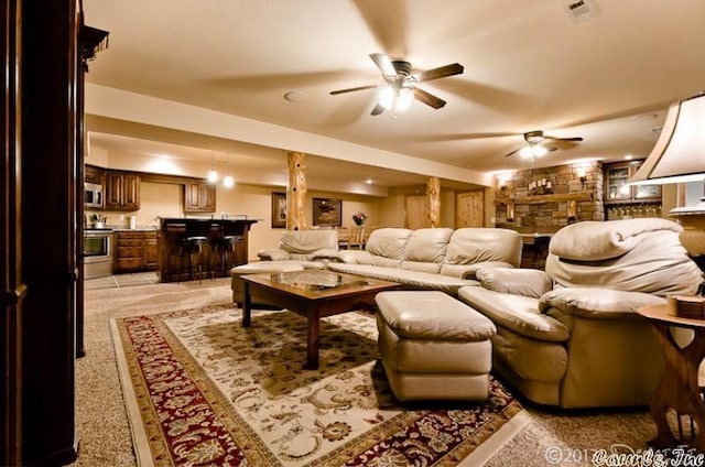 69 Jackson Rdg, Eureka Springs, AR 72631 - carpeted living room featuring ceiling fan and a stone fireplace