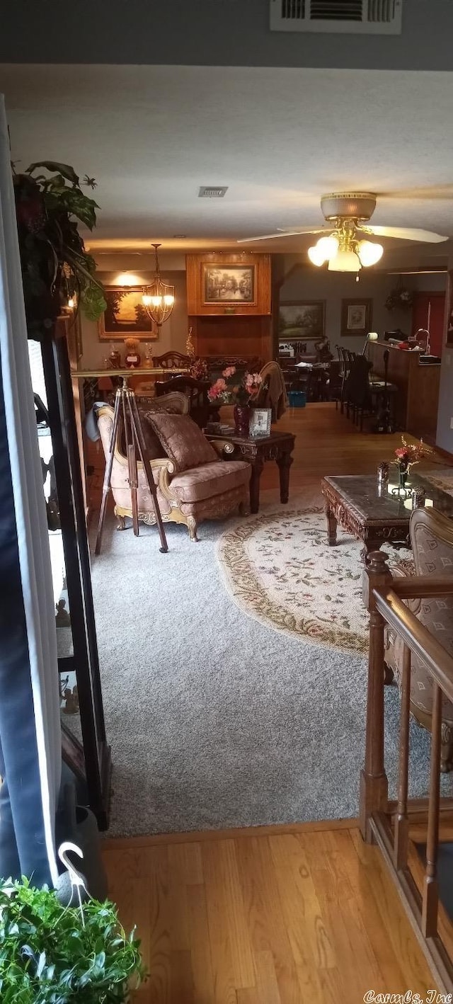 unfurnished living room with ceiling fan and hardwood / wood-style floors