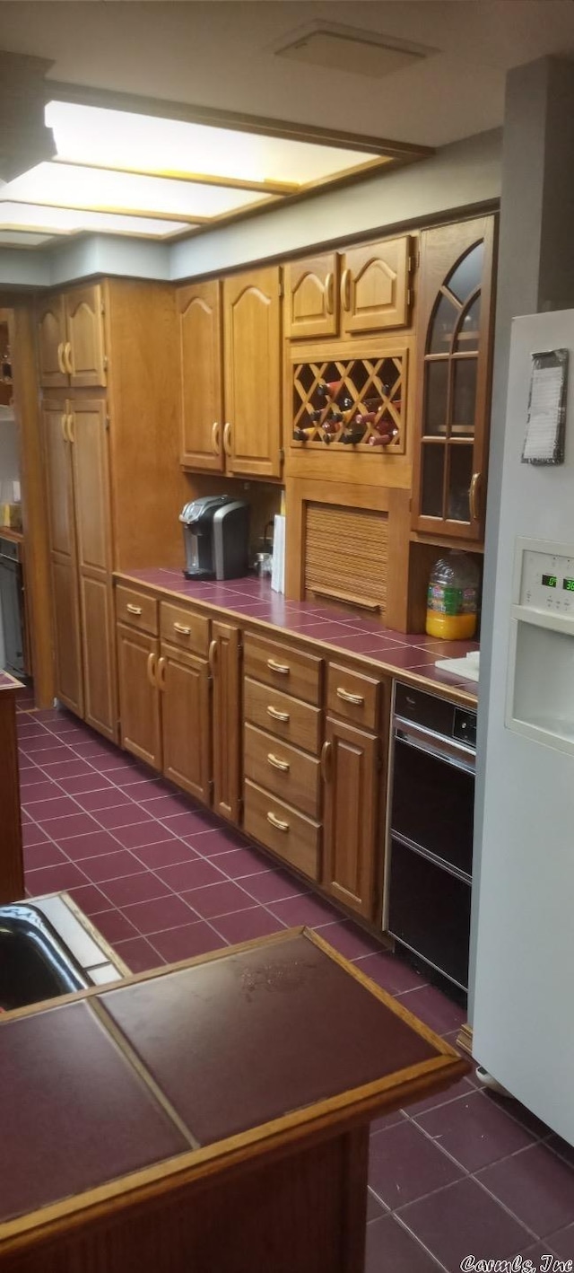 kitchen featuring dark tile patterned floors