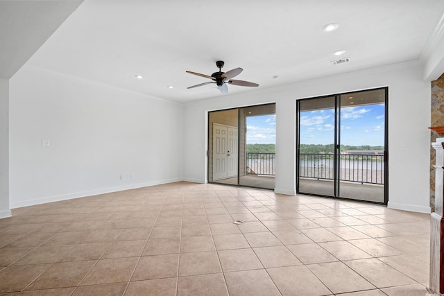 unfurnished room with ceiling fan, a water view, ornamental molding, and light tile flooring