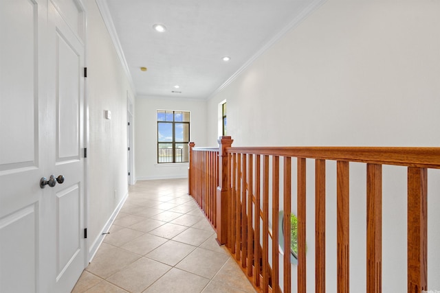 hallway featuring crown molding and light tile floors