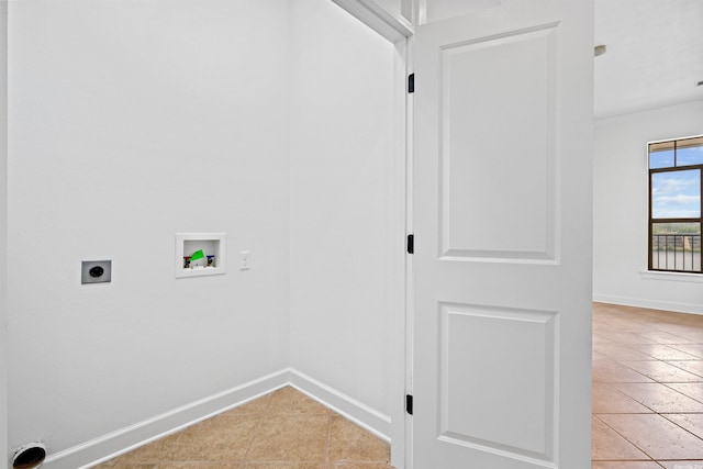 washroom featuring electric dryer hookup, washer hookup, and light tile floors