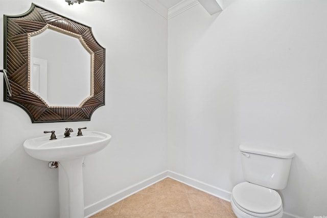 bathroom featuring toilet, tile flooring, and ornamental molding