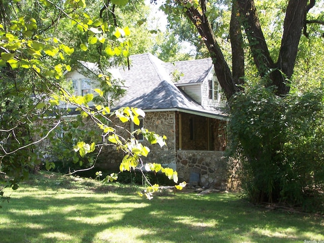 view of property exterior with a yard