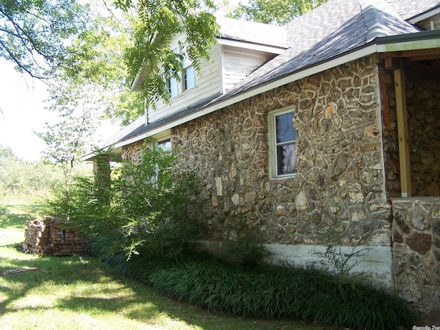 view of side of home with a lawn