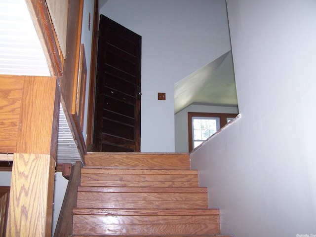 stairs featuring lofted ceiling