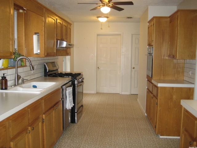 kitchen featuring backsplash, ceiling fan, and stainless steel appliances