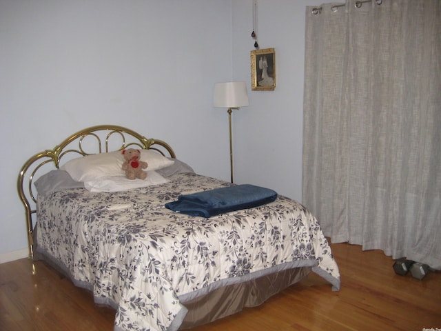 bedroom with hardwood / wood-style floors