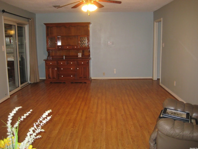 unfurnished living room with ceiling fan and hardwood / wood-style flooring