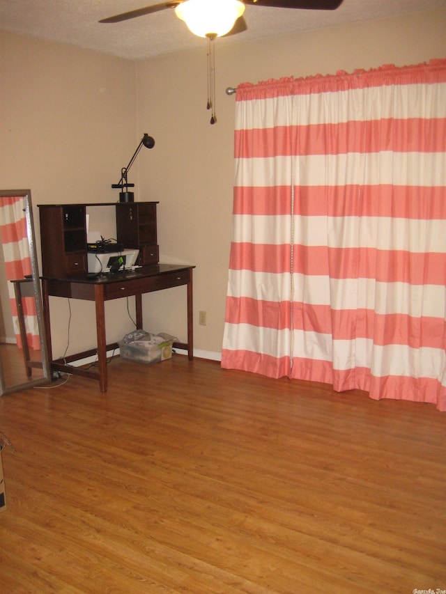 office with ceiling fan, hardwood / wood-style floors, and a textured ceiling