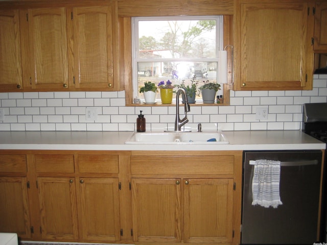 kitchen featuring dishwasher, tasteful backsplash, and sink