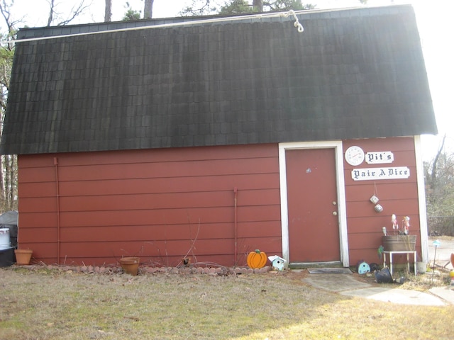 garage with wooden walls and a lawn