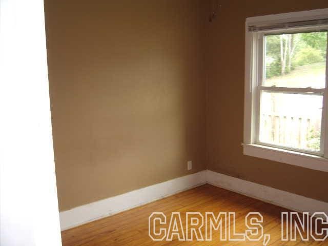 empty room with light hardwood / wood-style flooring