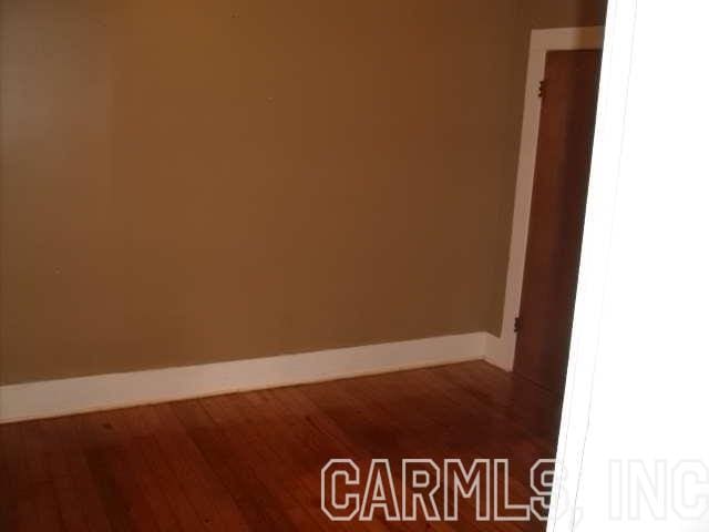 spare room featuring dark hardwood / wood-style floors