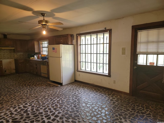 kitchen featuring white appliances, tasteful backsplash, ceiling fan, and a healthy amount of sunlight