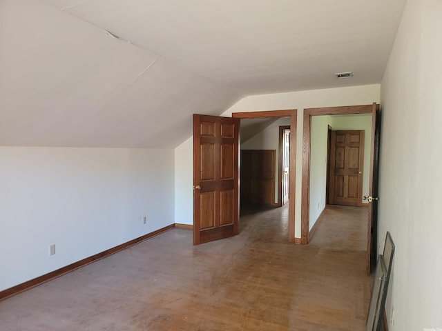 additional living space featuring lofted ceiling