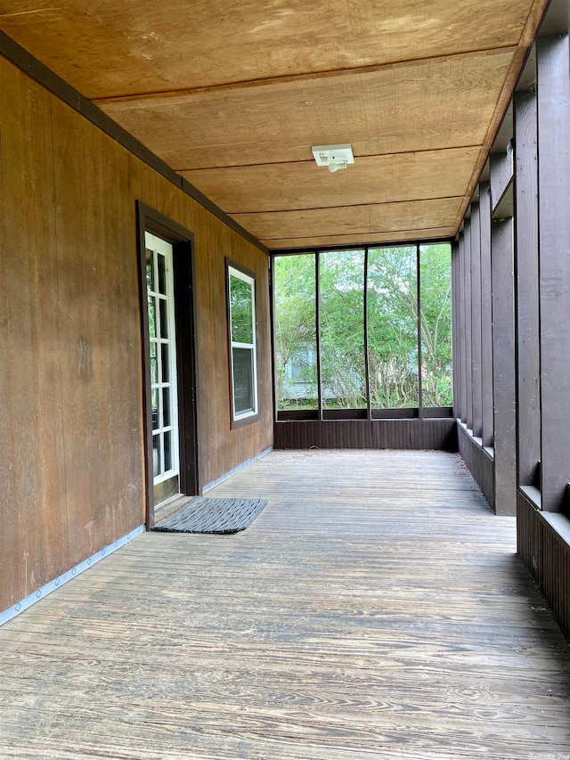 unfurnished sunroom with wooden ceiling