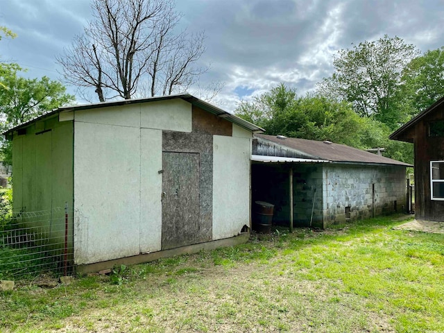 view of outbuilding featuring a lawn