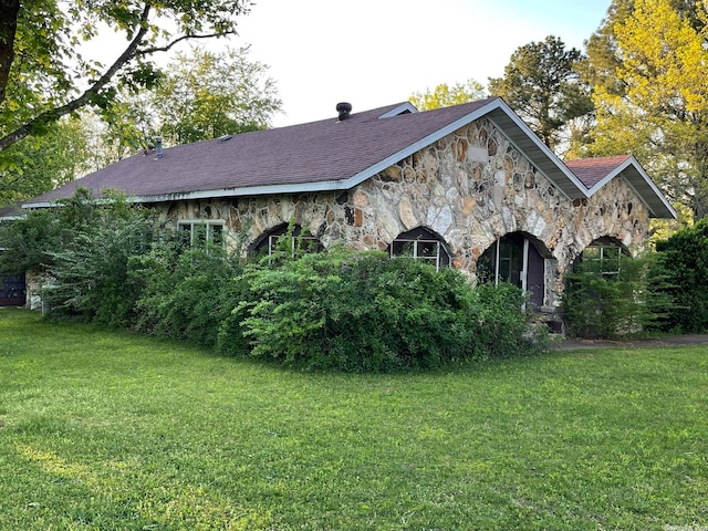 view of side of home featuring a yard