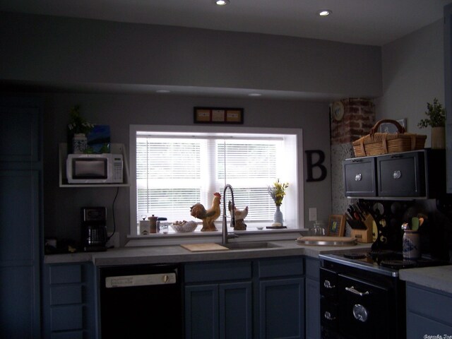 kitchen with black dishwasher, white microwave, and sink