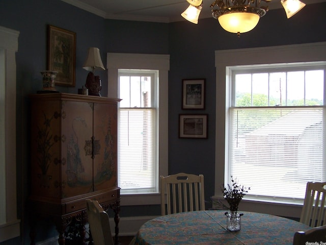 dining room featuring a chandelier, crown molding, and a wealth of natural light