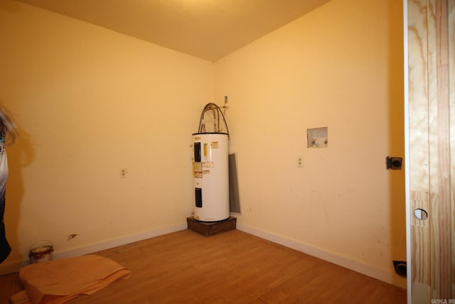 interior space featuring hardwood / wood-style floors, hookup for a washing machine, and water heater