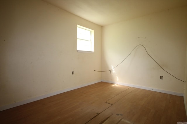 spare room with hardwood / wood-style flooring