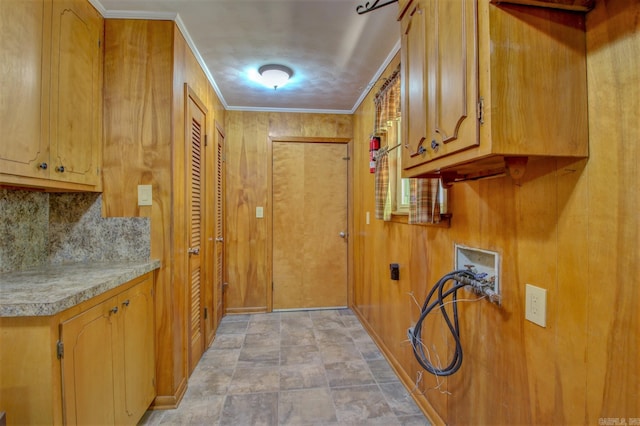 kitchen featuring crown molding, backsplash, and light tile floors