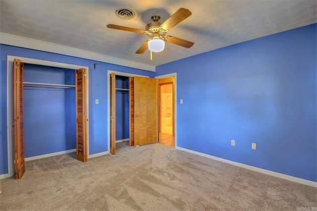 unfurnished bedroom featuring ceiling fan and light colored carpet