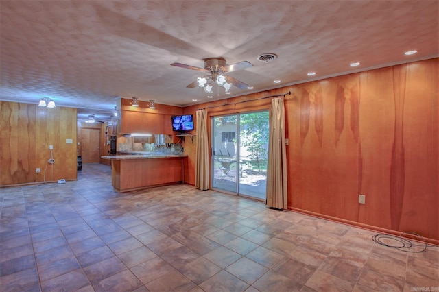 kitchen with ceiling fan, backsplash, light tile flooring, and kitchen peninsula