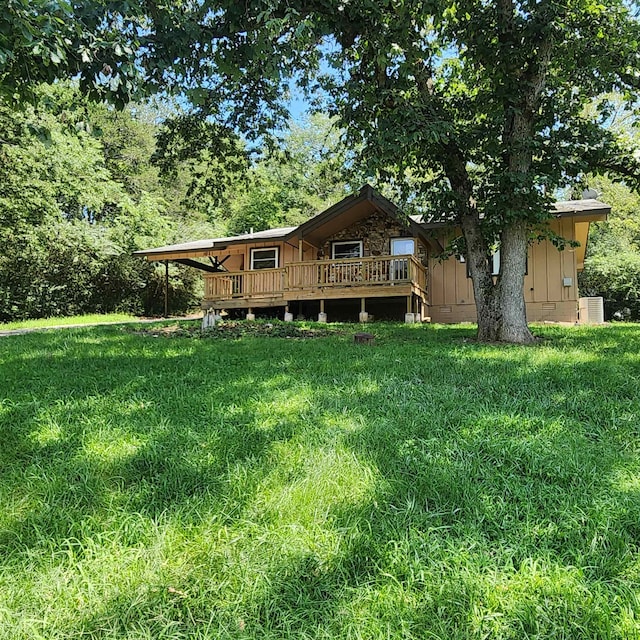 view of yard featuring a deck and central AC unit