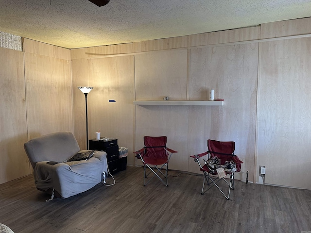 living area featuring a textured ceiling and wood finished floors