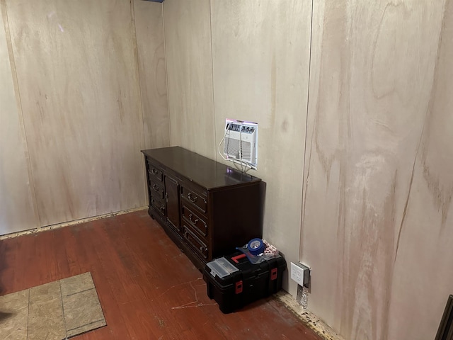 miscellaneous room featuring dark wood-style floors and an AC wall unit