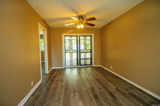 empty room featuring a textured ceiling, ceiling fan, and dark hardwood / wood-style flooring