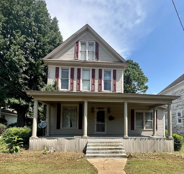 greek revival inspired property featuring a porch