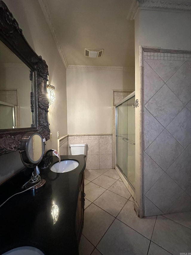 bathroom featuring vanity, walk in shower, tile walls, tile flooring, and ornamental molding