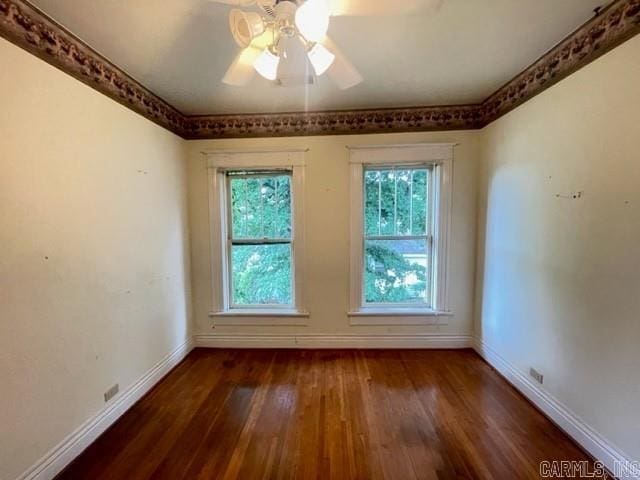 unfurnished room with dark hardwood / wood-style flooring and ceiling fan