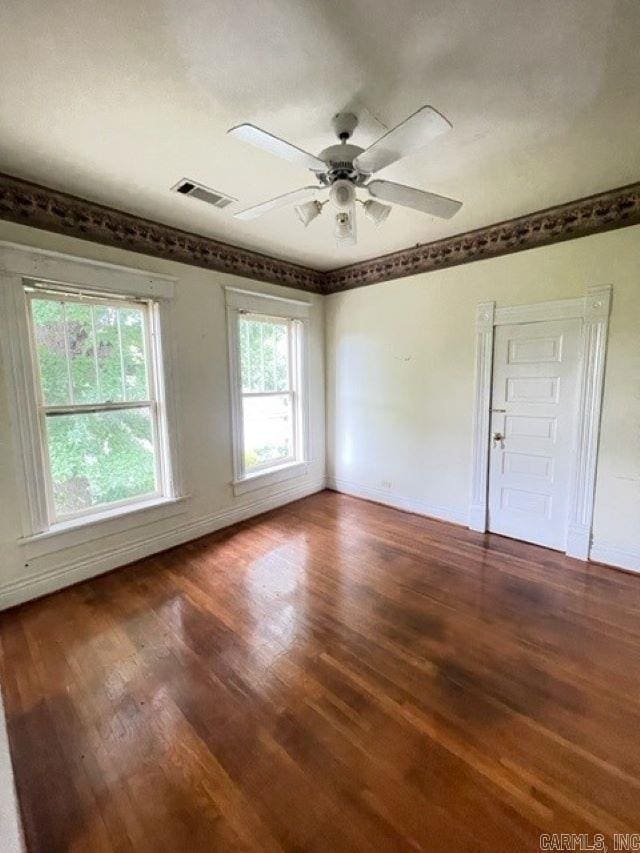 unfurnished room with dark hardwood / wood-style floors and ceiling fan