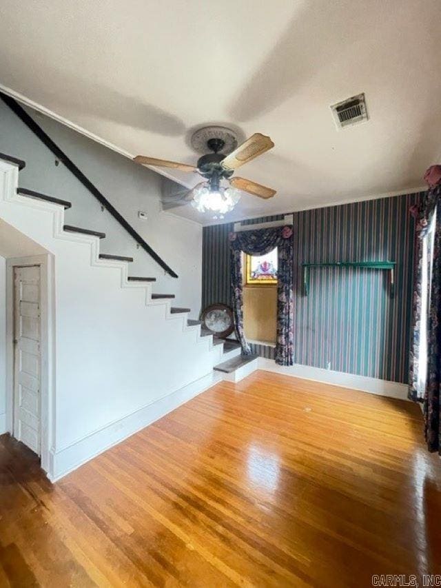 unfurnished living room with ceiling fan and light wood-type flooring