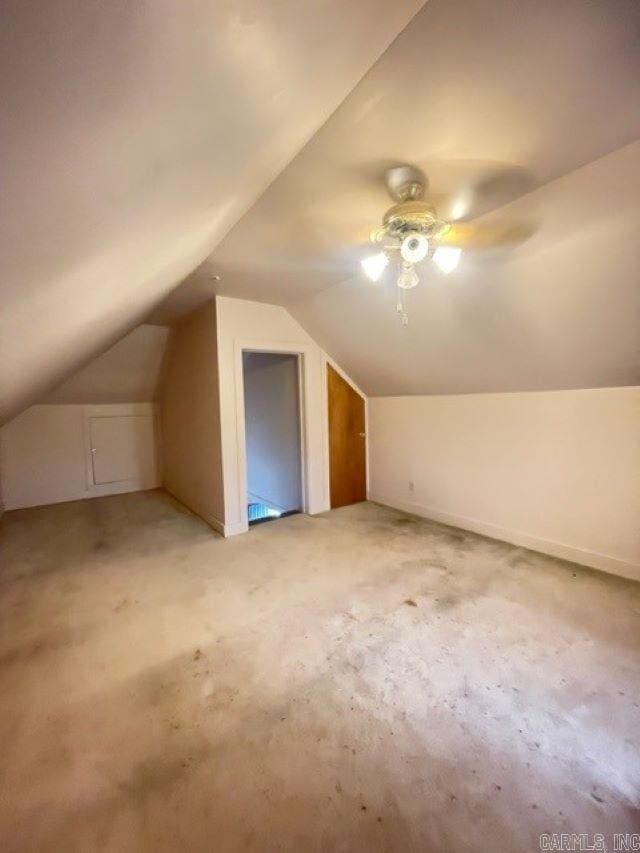 additional living space featuring vaulted ceiling and ceiling fan