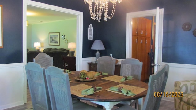 dining space featuring a chandelier and wood-type flooring