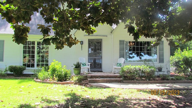 doorway to property featuring a yard