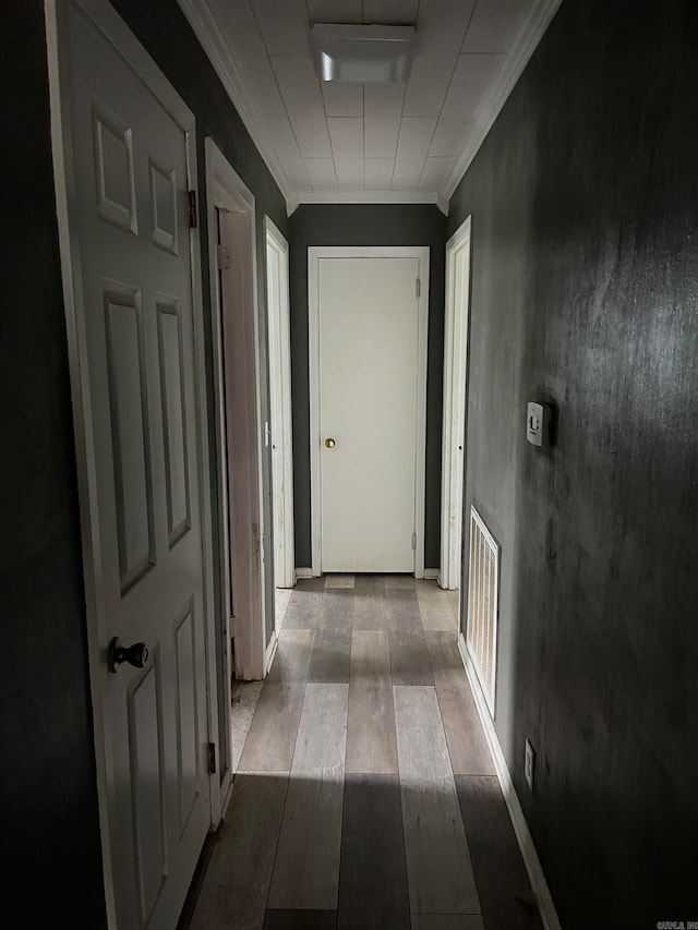 hallway with crown molding and dark wood-type flooring