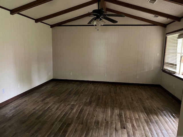 spare room with ceiling fan, vaulted ceiling with beams, dark hardwood / wood-style floors, and a textured ceiling