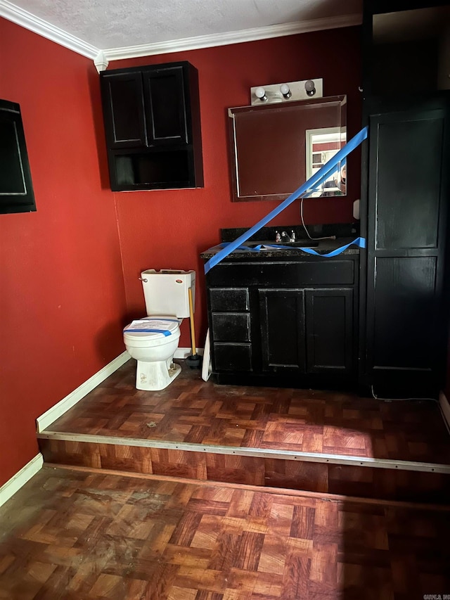 bathroom with crown molding, toilet, a textured ceiling, and parquet floors