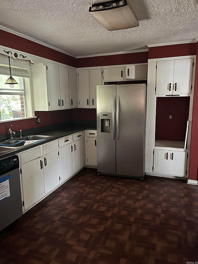 kitchen featuring white cabinetry, stainless steel appliances, dark parquet flooring, pendant lighting, and sink