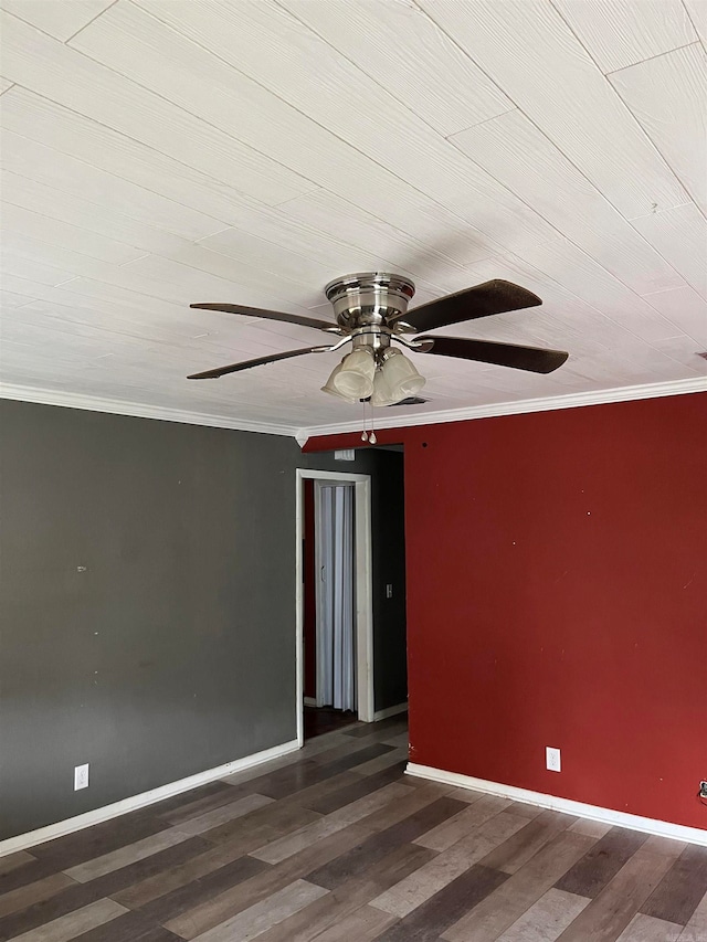 spare room featuring dark hardwood / wood-style flooring, ceiling fan, and ornamental molding