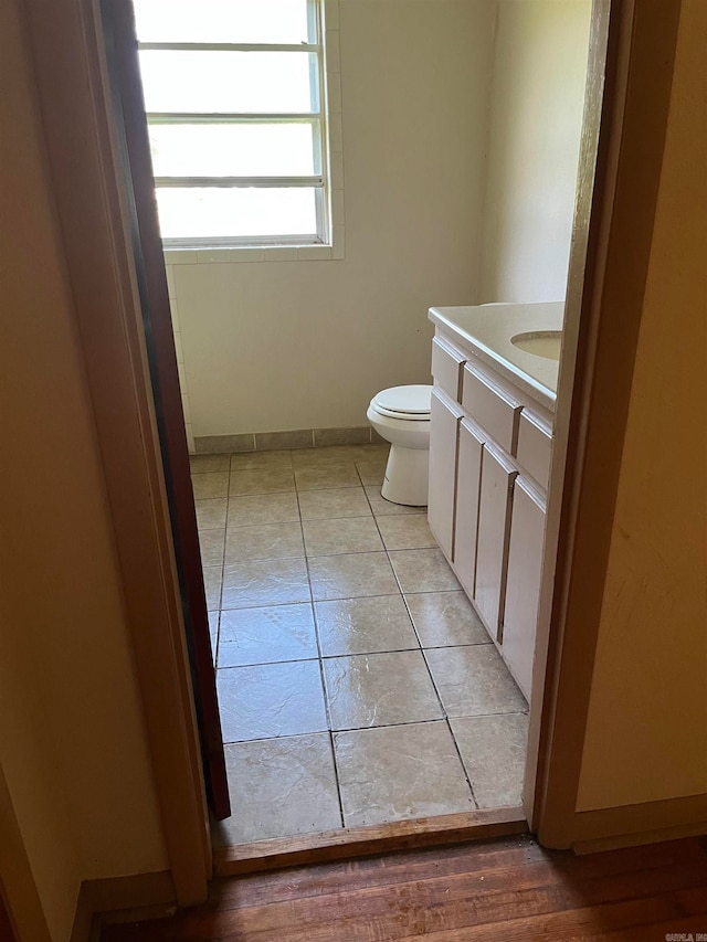 bathroom featuring tile floors, toilet, and vanity