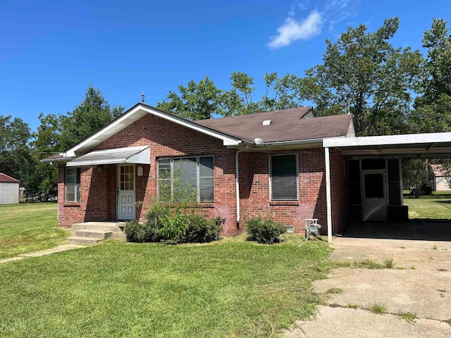 ranch-style house with a carport and a front lawn